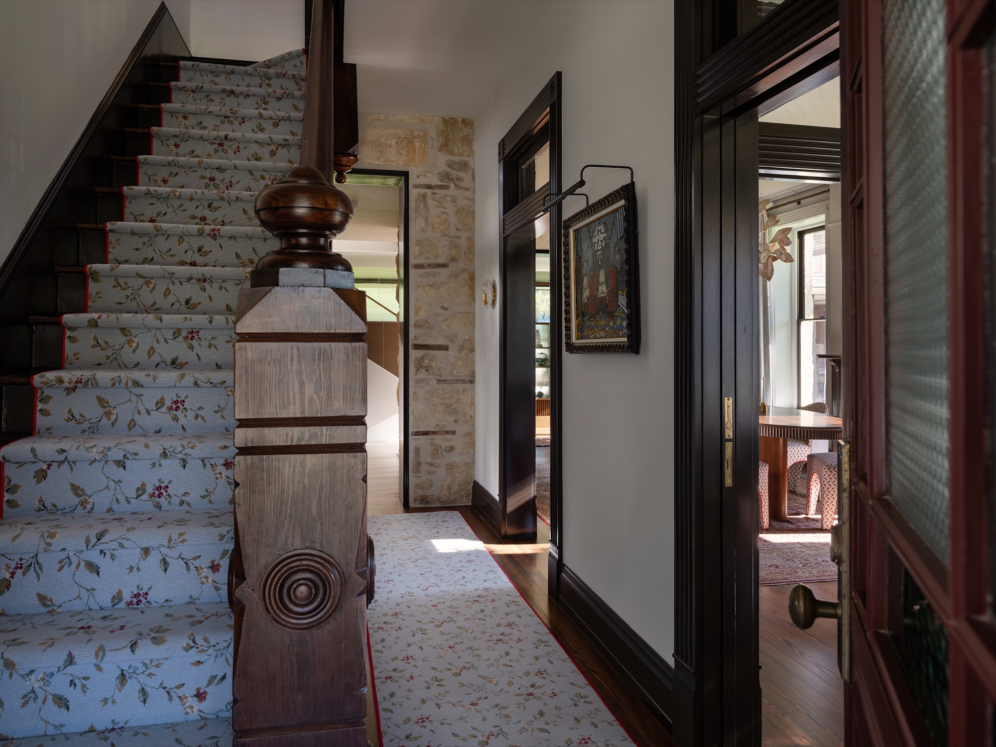 Victorian House stair hall with newel post and transom windows in Austin, Texas